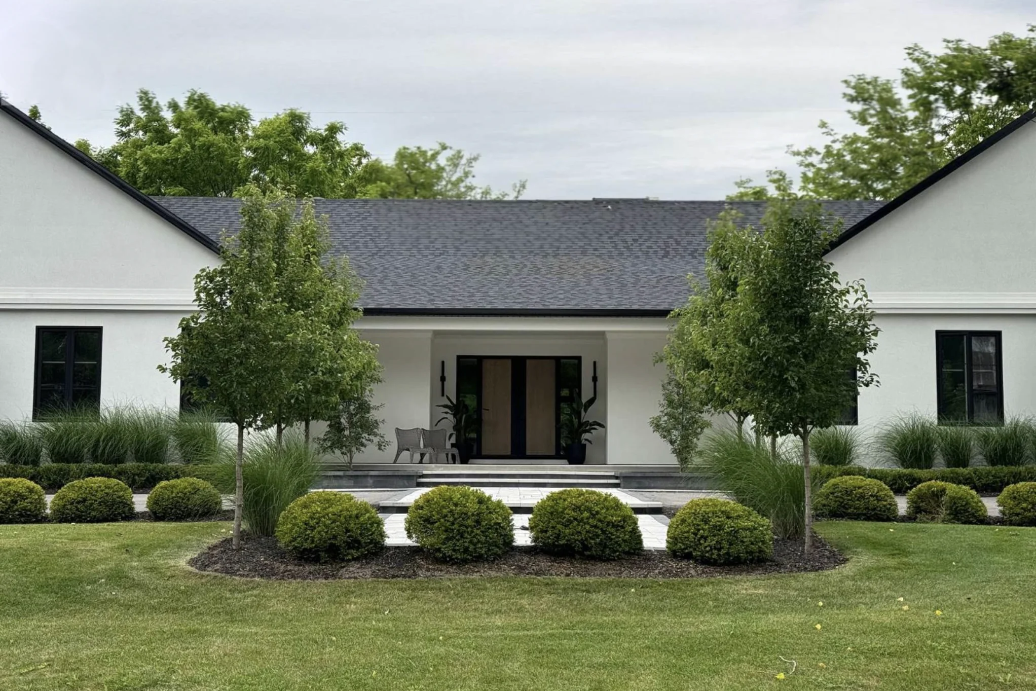 White single-storey house with lawn in front